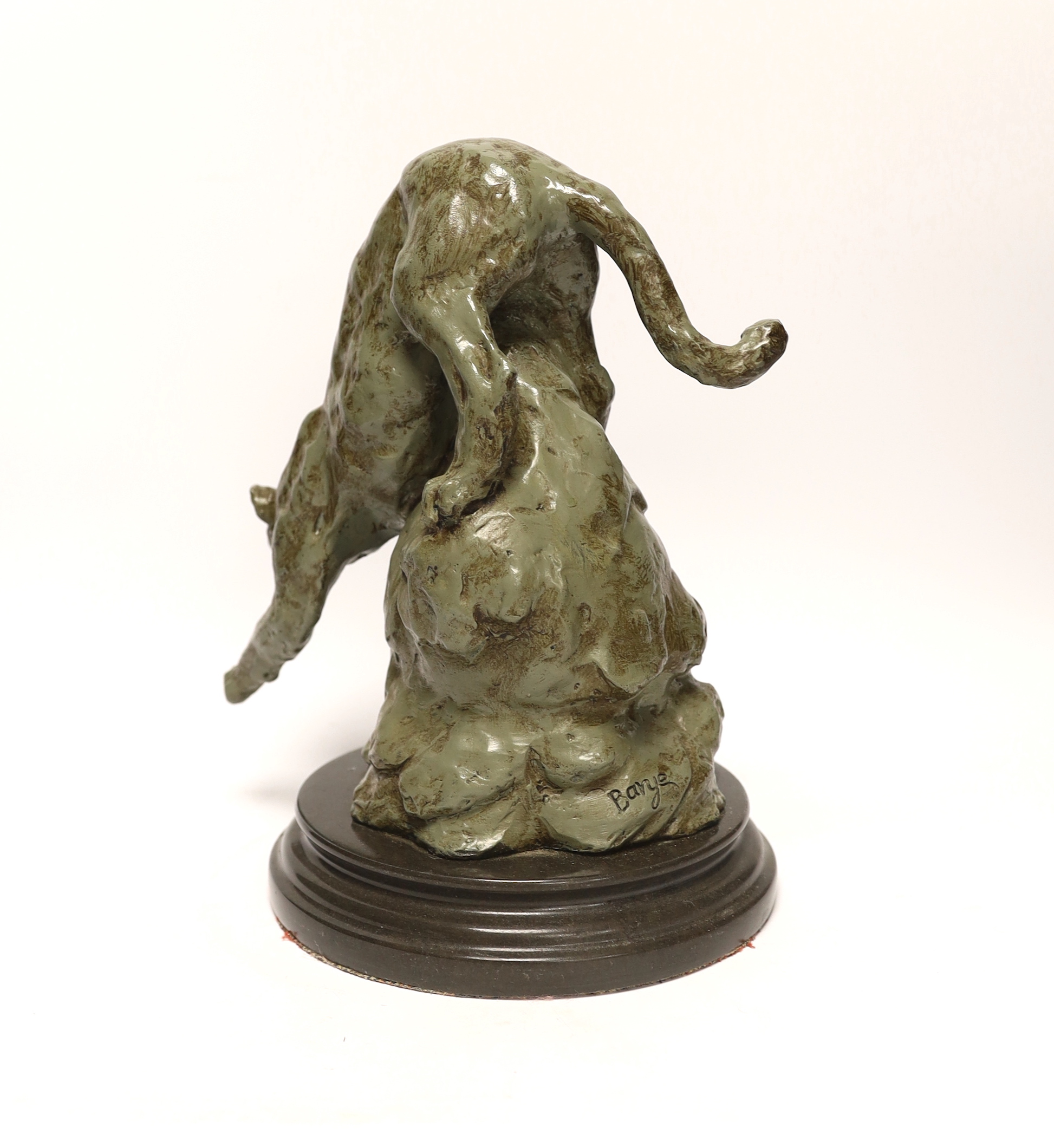 After Antoine Louis Barye, a patinated metal study of a leopard, raised on shaped circular base, 28cm high